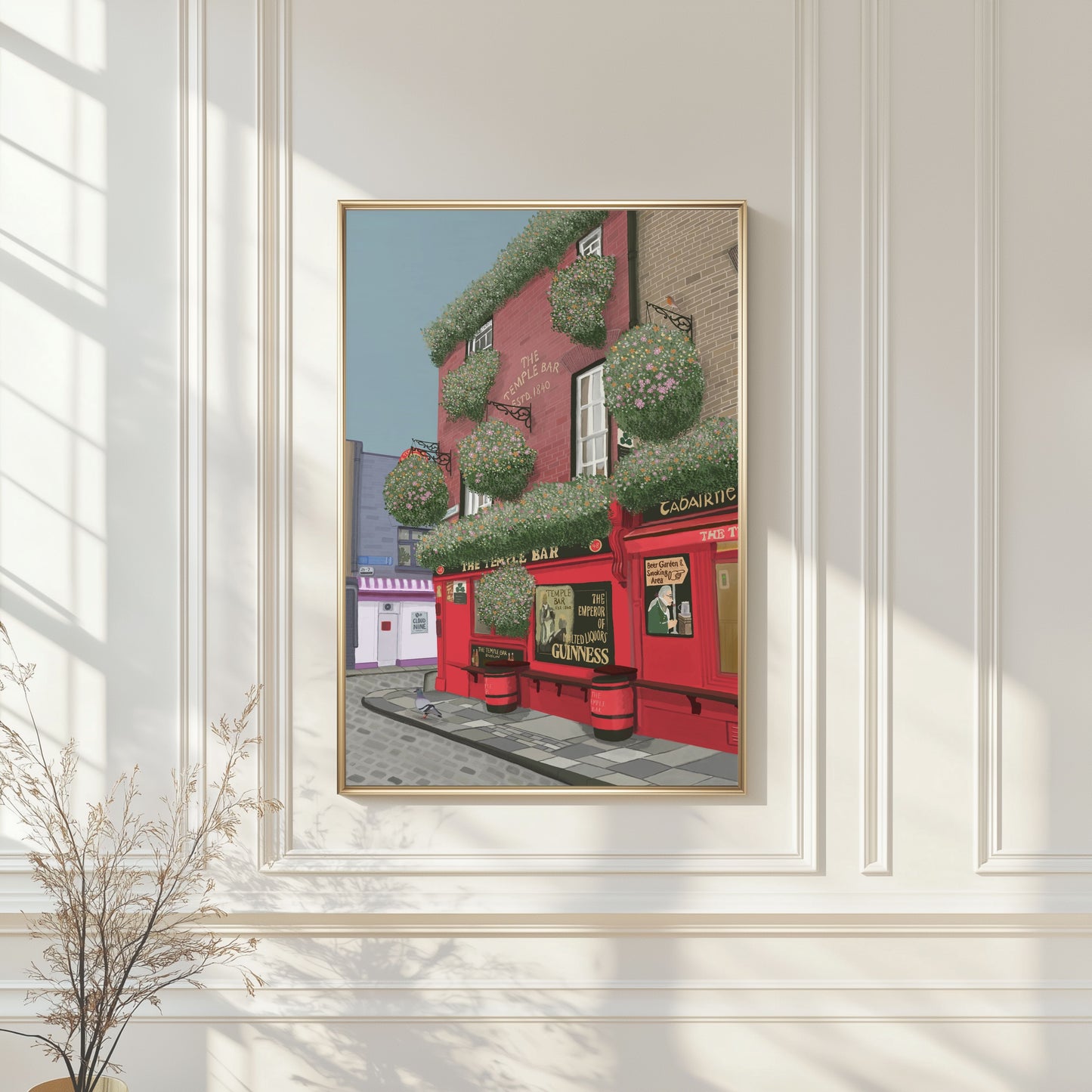 Hand-illustrated fine art print of Temple Bar, Dublin displayed in a light oak frame in a bright, modern living room.